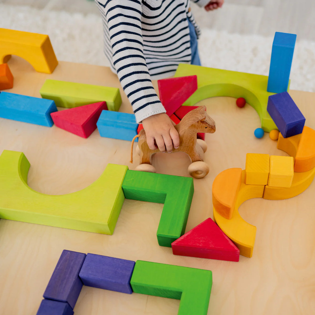 Create, stack and build with Grimm's Basic Building Set. A 30-piece wooden block set designed to inspire imaginative, open-ended play from an early age.