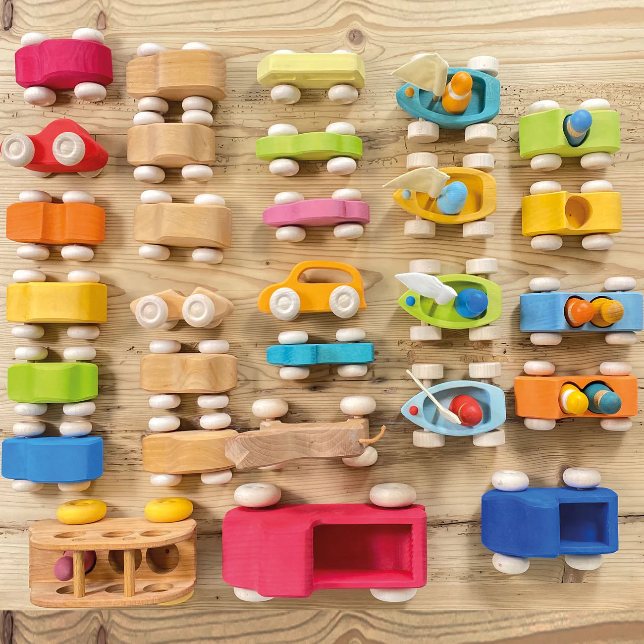 Grimm's Wooden Bus and other vehicles on shelf taken from above.