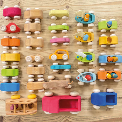Grimm's Wooden Bus and other vehicles on shelf taken from above.