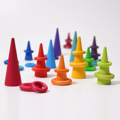 Grimms colourful wooden cones arranged in a row on a white background