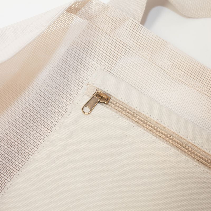 Internal zipper pocket in sand keeping valuables safe while at beach. 