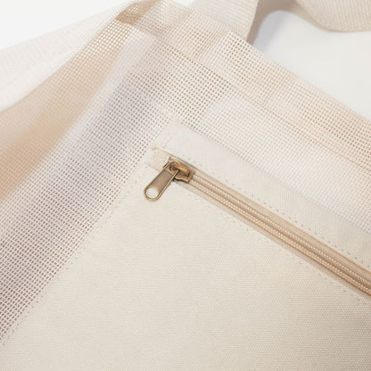 Internal zipper pocket in sand keeping valuables safe while at beach. 