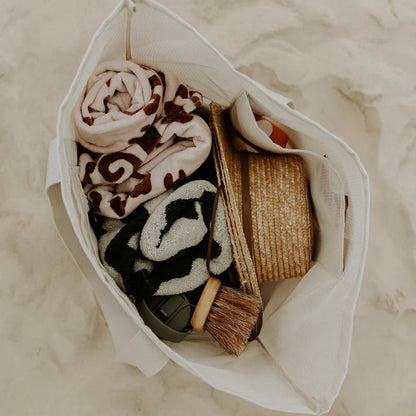 Sande Kids mesh beach bag packed with towels on sand