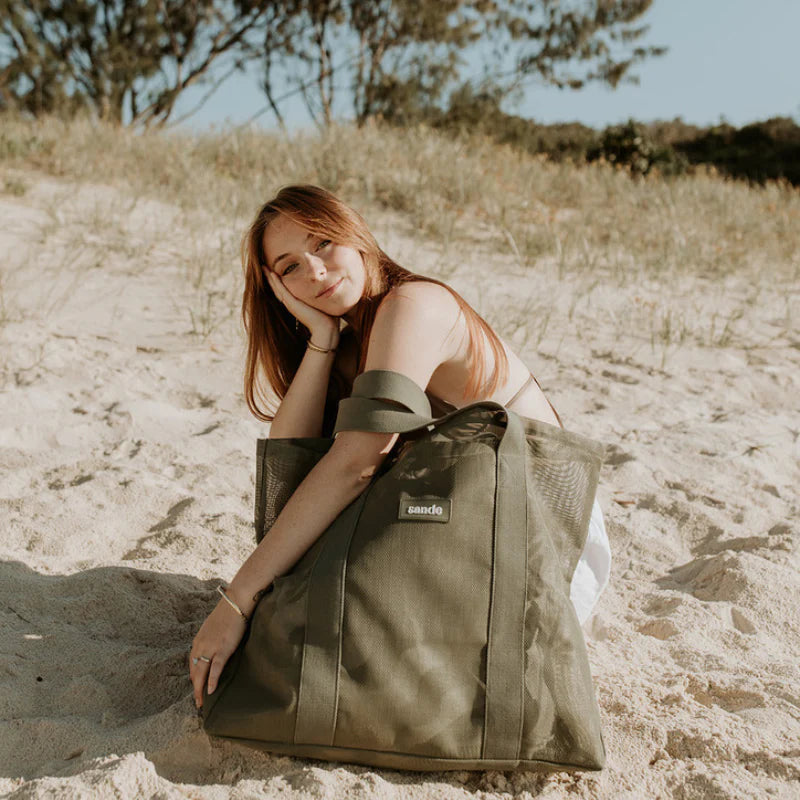 girl with mini beach hauler bag in olive green.
