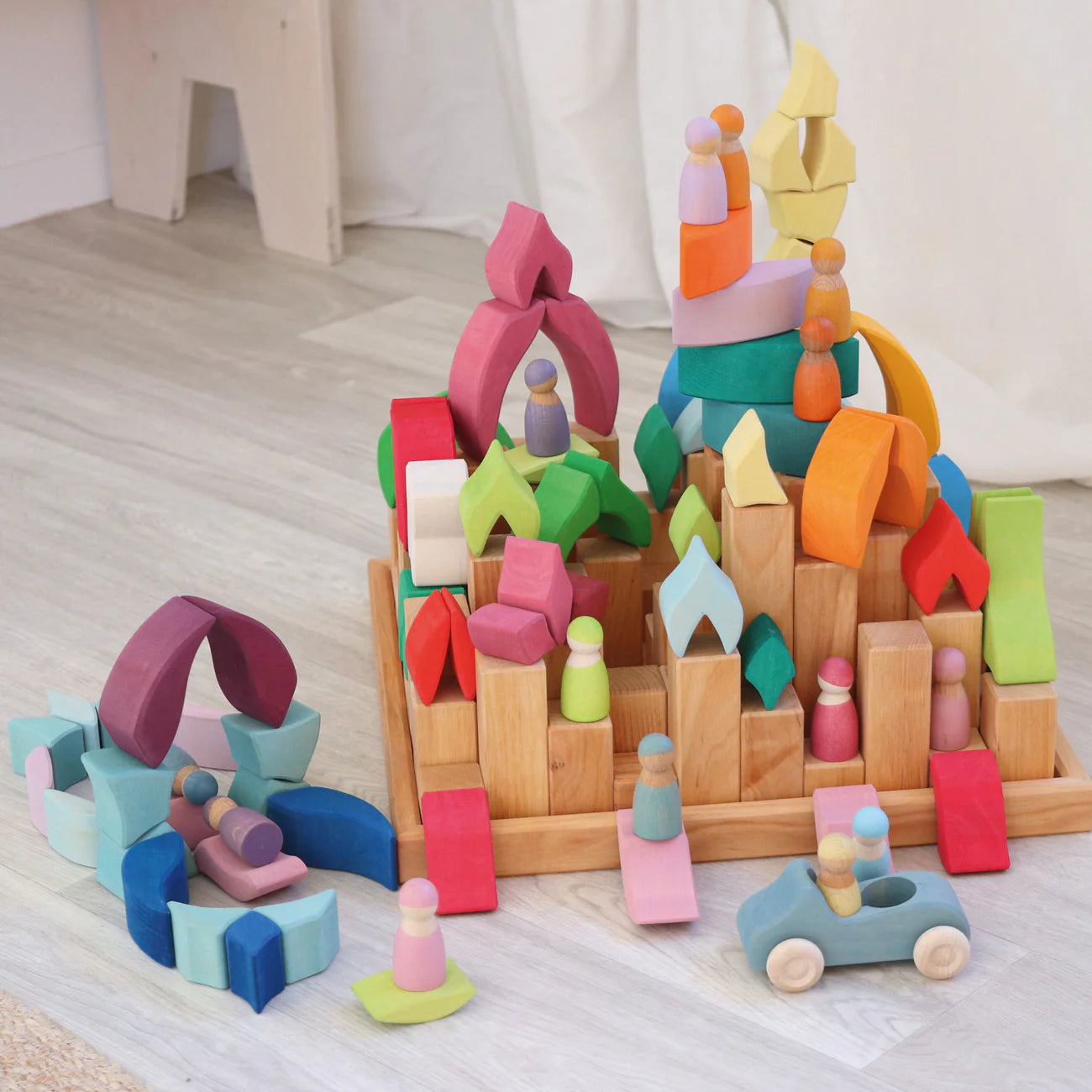 Grimm's Building Set Lara with 73 colourful curved wooden blocks for imaginative building and open-ended play.