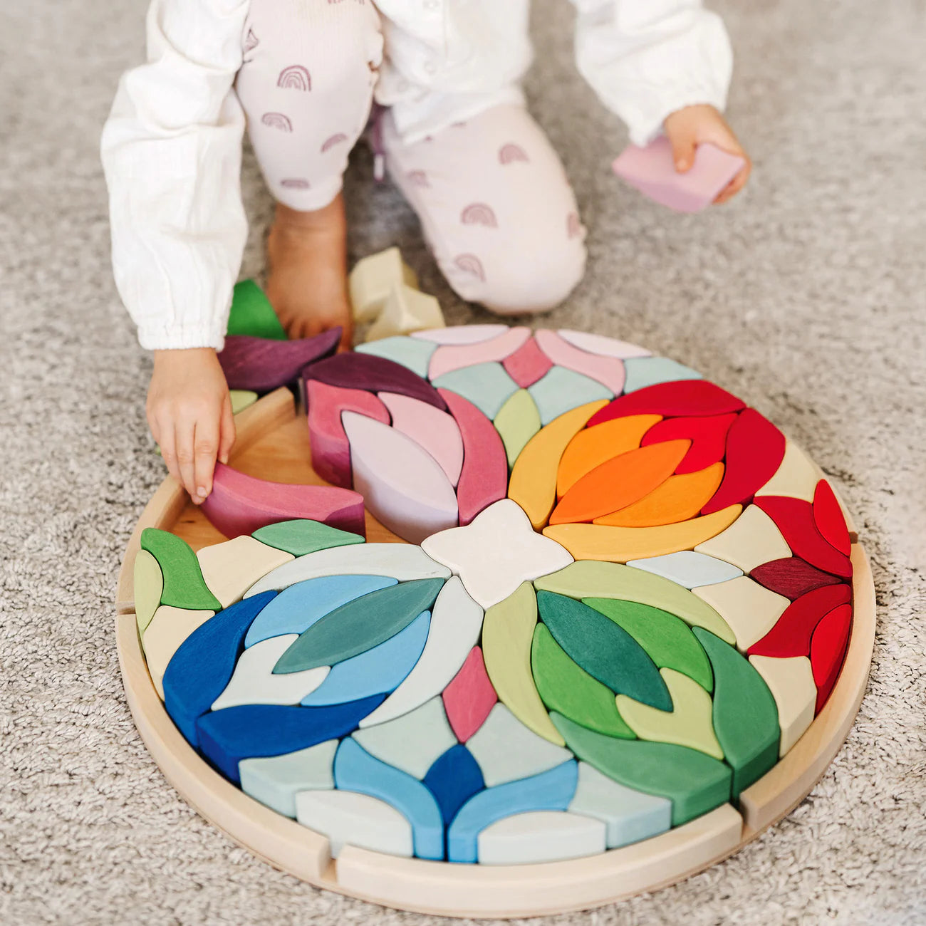 Grimm's Building Set Lara with 73 colourful curved wooden blocks for imaginative building and open-ended play.