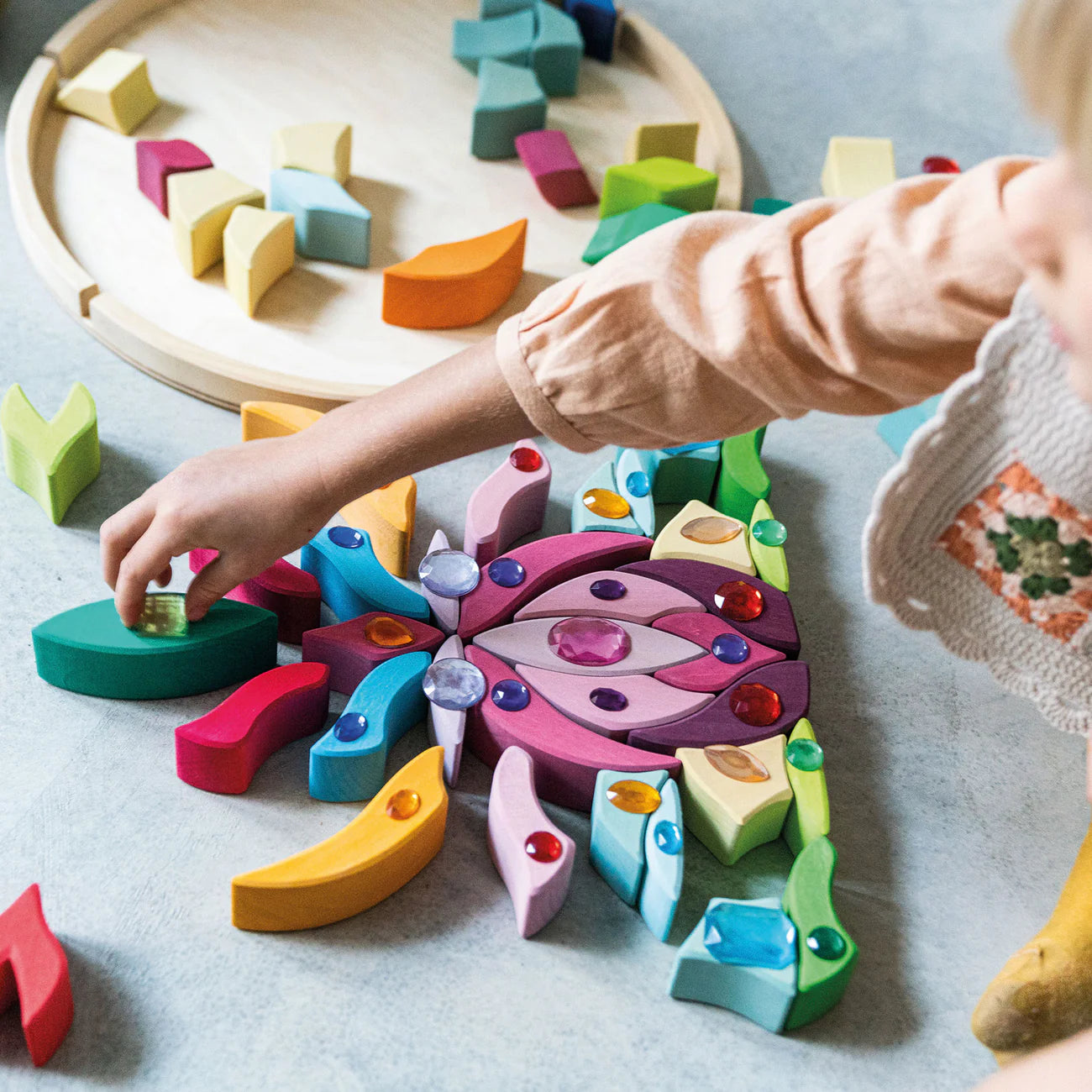 Grimm's Building Set Lara with 73 colourful curved wooden blocks for imaginative building and open-ended play.