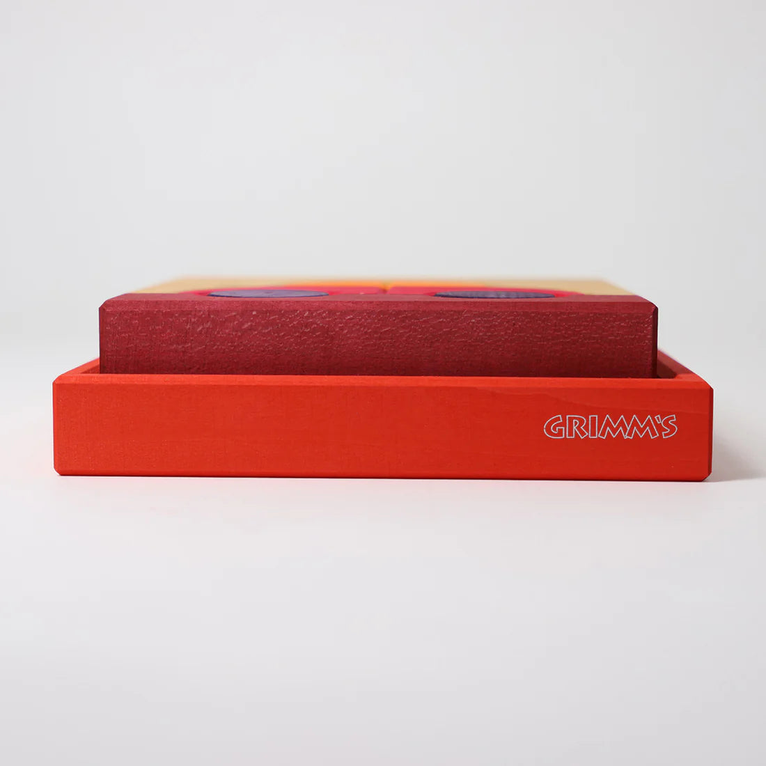 Grimm's Red Building Set with large red wooden blocks for creative building and open-ended imaginative play.