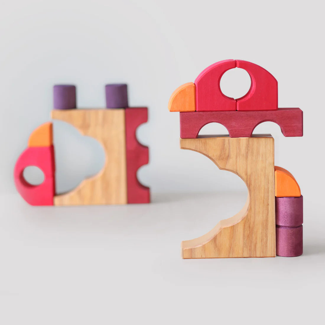 Grimm's Red Building Set with large red wooden blocks for creative building and open-ended imaginative play.