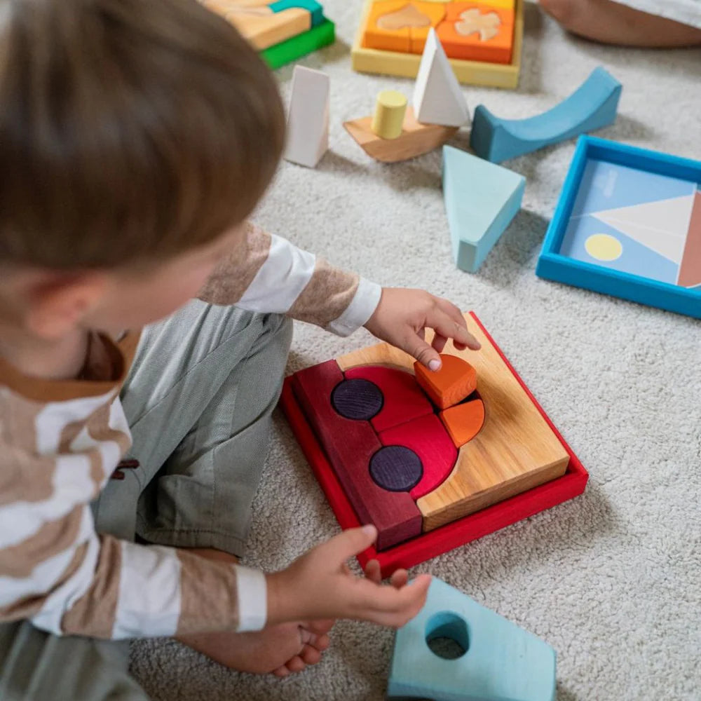Grimm's Red Building Set with large red wooden blocks for creative building and open-ended imaginative play.