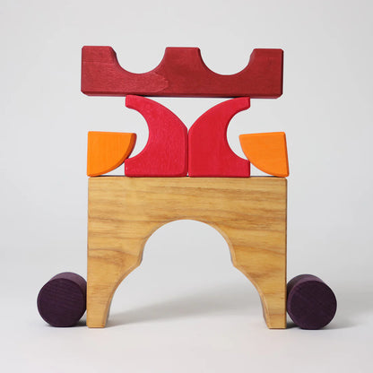 Grimm's Red Building Set with large red wooden blocks for creative building and open-ended imaginative play.