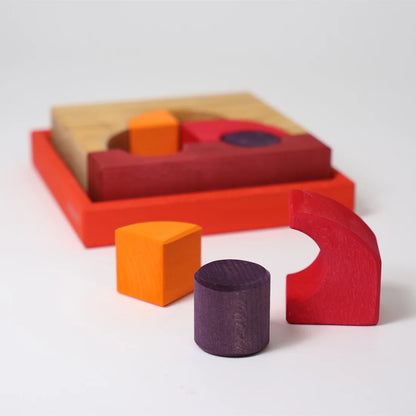 Grimm's Red Building Set with large red wooden blocks for creative building and open-ended imaginative play.