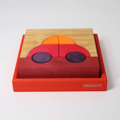 Grimm's Red Building Set with large red wooden blocks for creative building and open-ended imaginative play.
